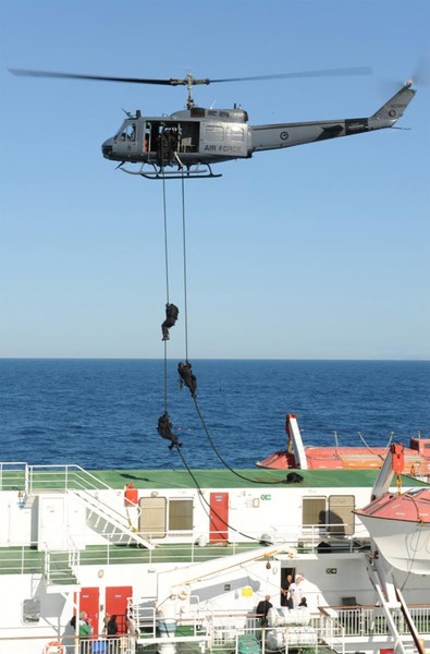 Members of the police Special Tactics Group rappel out of a RNZAF Iroquois onto the Aretere Interislander ferry during a combined training exercise.